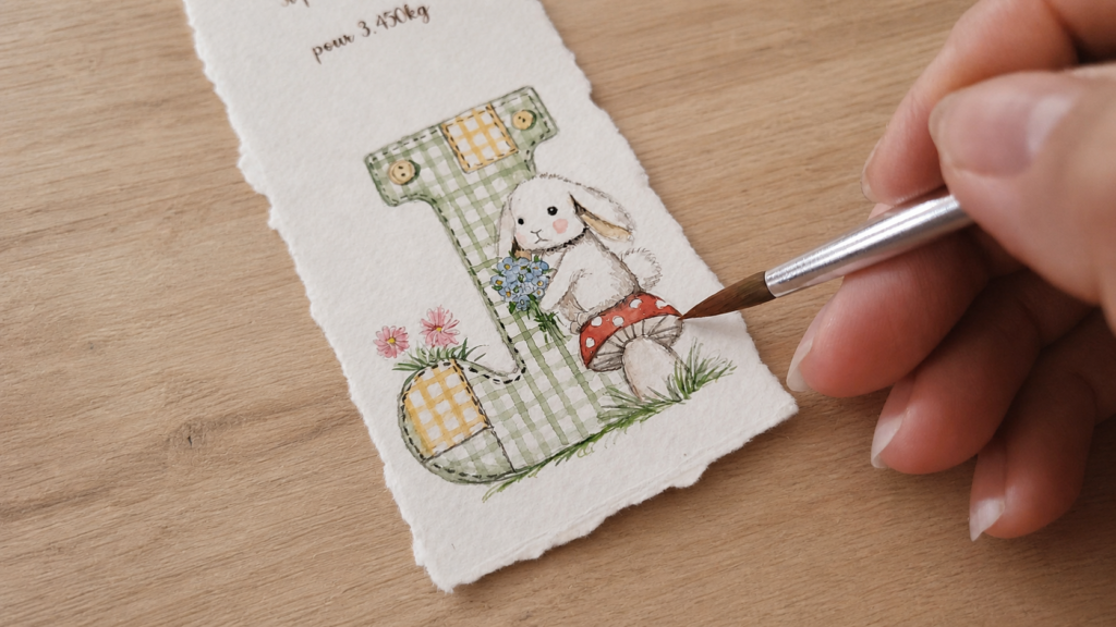 Gros plan à l'aquarelle d'un détail de faire-part de naissance